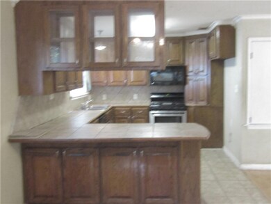 View from dining room into kitchen.  Breakfast bar