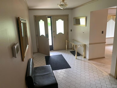 Foyer featuring plenty of natural light and ornamental molding