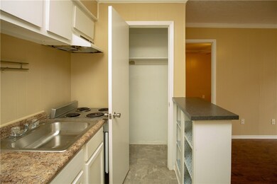 Kitchen featuring electric stove, crown molding, w