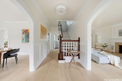 Beyond the cheerful mint-hued front door, the entryway serves as the heartbeat of the home—perfectly poised between the formal dining and living rooms, setting a tone of timeless charm and warmth.