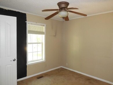 Carpeted empty room featuring a textured ceiling, 