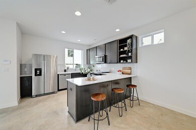 Kitchen featuring open shelves, appliances with s