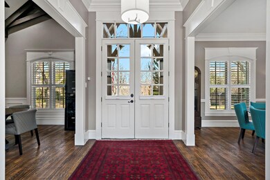 Entry with Stately Front Door, Case Moldings, Rais