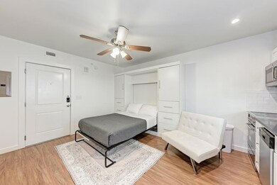 Bedroom with light wood finished floors and ceili