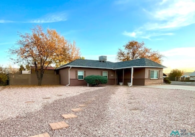 Ranch-style home with a shingled roof and stucco siding