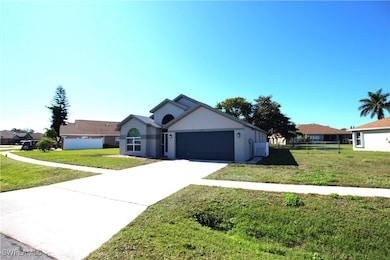 Single story home featuring a front yard and a garage