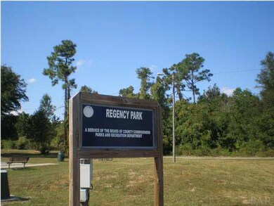 Neighborhood Park with a fenced dog park across the street from Regency Park
