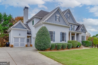 Side-entry garage and wide driveway provide easy access and extra parking.