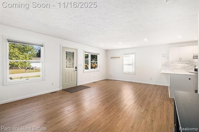 The Living Room is light, bright and airy and opens to the Dining Area and Kitchen.