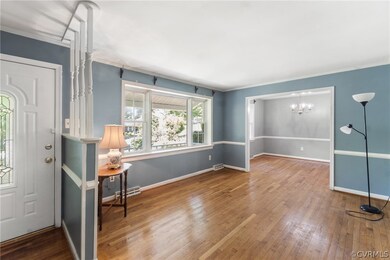 Entryway featuring an inviting chandelier, crown m