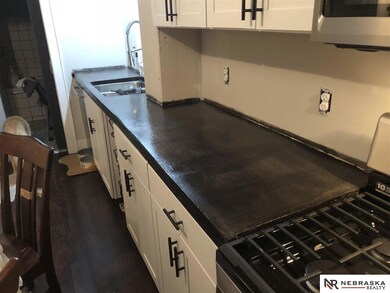 Gas stove and microwave, high end dishwasher! New cabinets concrete countertops need windows and floors and trim huge eat in kitchen!