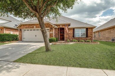 Ranch-style home featuring concrete driveway, roof