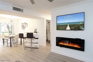 Living area featuring a lit fireplace, ornamental