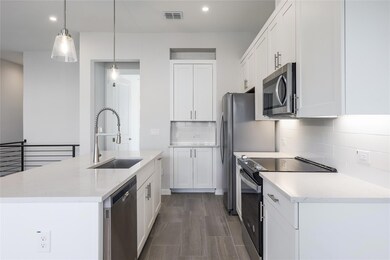 Kitchen featuring stainless steel appliances, white cabinetry, tasteful backsplash, pendant lighting, and recessed lighting