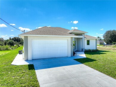 Ranch-style home featuring a front lawn, stucco siding, and concrete driveway
