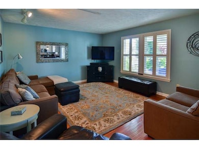 Family Room. Large windows with wooden blinds make
