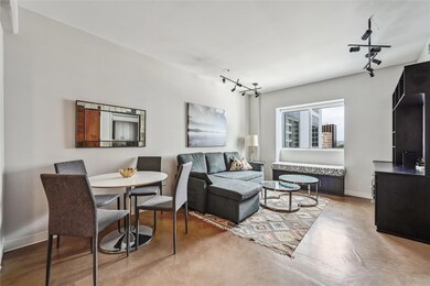 Living room featuring baseboards, track lighting,