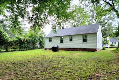 Back of property featuring a yard