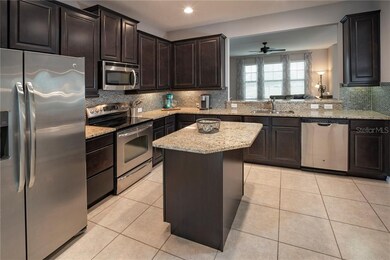 Kitchen features stainless appliances, granite cou