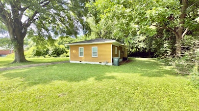 View of property exterior featuring crawl space and a lawn