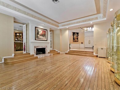 Formal living room with steps leading to family ro