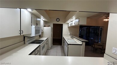 Kitchen featuring sink, light tile patterned floor