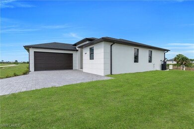 View of property exterior with a lawn, stucco sidi