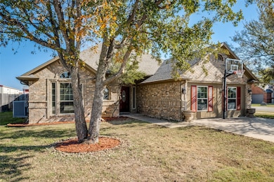 View of front of property with brick siding and roof with shingles