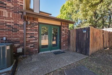 Property entrance featuring brick siding, french doors, and a chimney