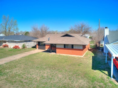 View of front facade with driveway, fence, roof wi