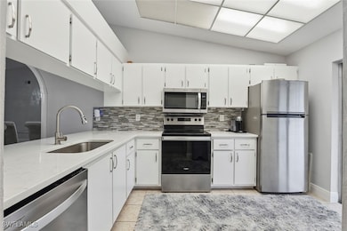 Kitchen featuring stainless steel appliances, a si