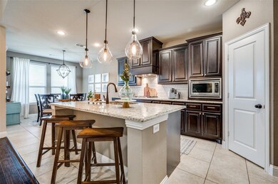 View of kitchen, center island with pendent lights