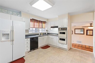 View of kitchen looking into the family room/den