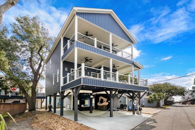 Coastal home with a ceiling fan, a balcony, a carport, and board and batten siding