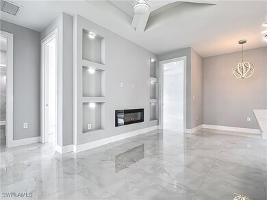 Unfurnished living room with built in shelves, lig