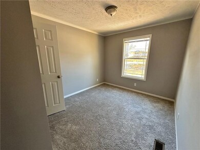 Unfurnished room featuring baseboards, visible ven
