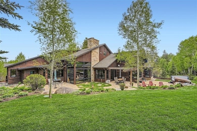 Back of house with a lawn, a patio area, and a chi
