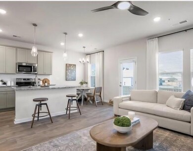 Living area with wood finished floors, recessed lighting, a ceiling fan, and a chandelier