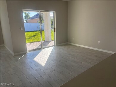 Empty room featuring Tile plank floors and baseboa