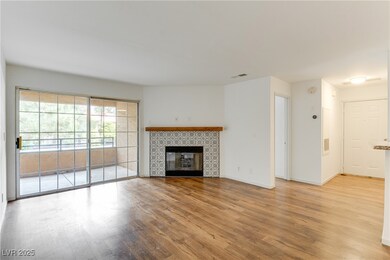 Unfurnished living room featuring wood finished fl