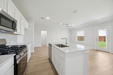 Kitchen in the Hadley home plan by Trophy Signature Homes – REPRESENTATIVE PHOTO