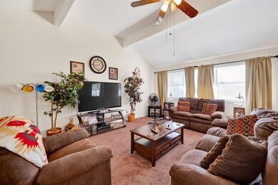 Living room with carpet floors and a ceiling fan