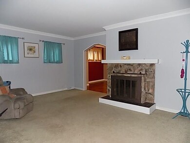 Living Room is accented with a decorative stone fi