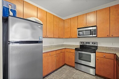 Kitchen featuring stainless steel appliances, lig