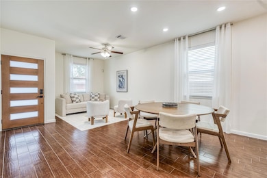 Dining room featuring dark wood-style floors, cei