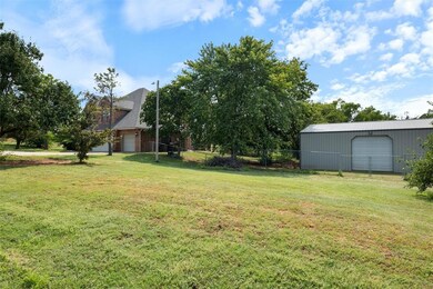 View of yard featuring an outbuilding and a garage