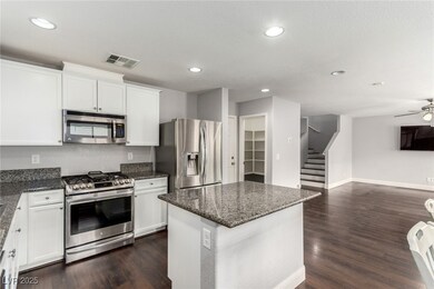 Kitchen featuring dark wood-style flooring, visibl