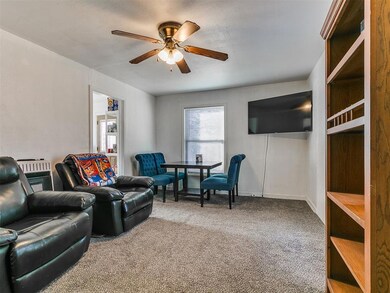 Living room with baseboards, carpet, and ceiling f