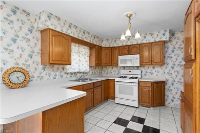 Kitchen with white appliances, tile flooring