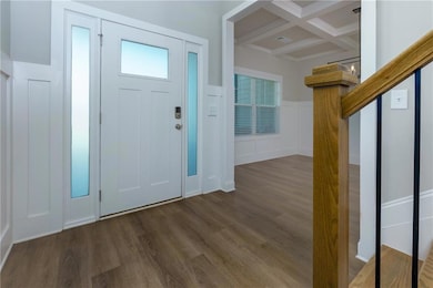 Entryway with beamed ceiling, dark hardwood / wood